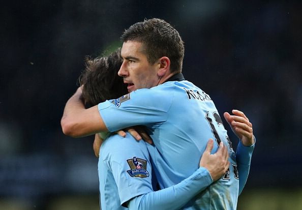 MANCHESTER, ENGLAND - MARCH 09: Aleksandar Kolarov of Manchester City celebrates with David Silva after scoring the second goal during the FA Cup sponsored by Budweiser sixth round match between Manchester City and Barnsley at Etihad Stadium